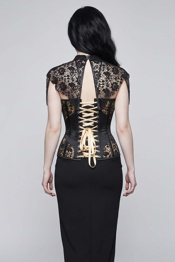 A woman shown from the  Luxe Noir Corset  back wearing a black lace corset top with gold embroidery and beige laces, paired with a black skirt, against a light gray studio background.