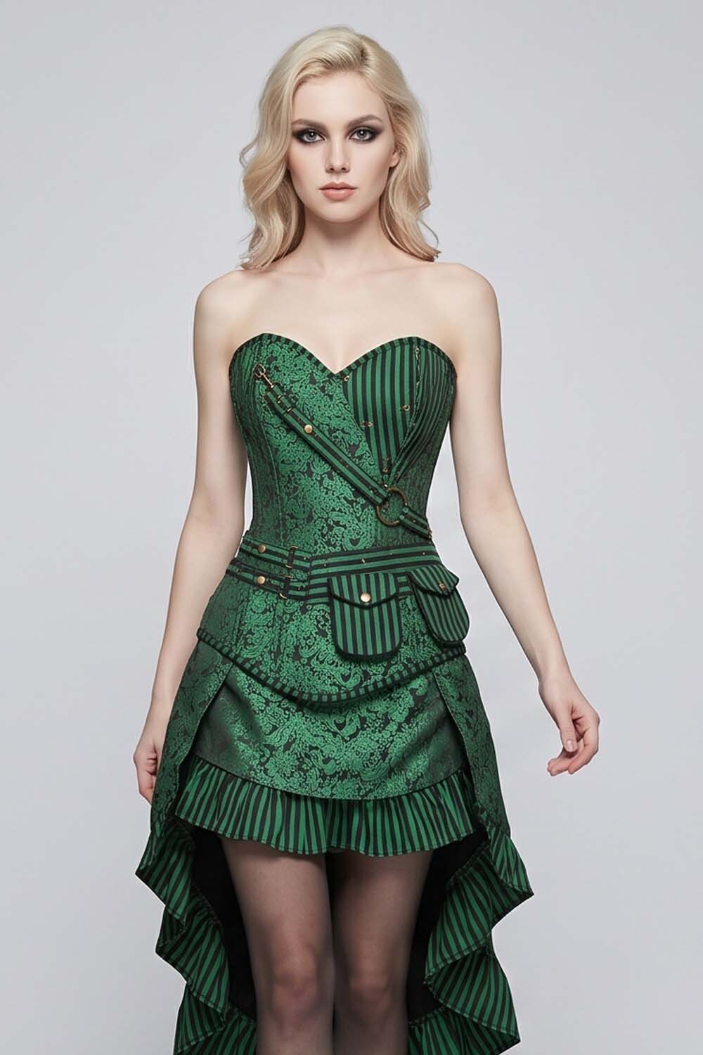 A blonde model wearing a strapless green LUXE NOIR CORSET corset-style dress with a high-low ruffled hem, textured pattern, and dark tights, photographed against a light gray studio background.